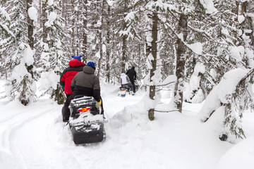 Athletes on a snowmobile