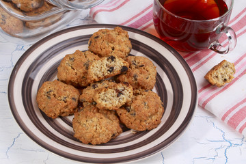 Oatmeal cookies on plate and cup of tea