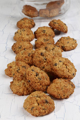 Oatmeal cookies scattered on white background