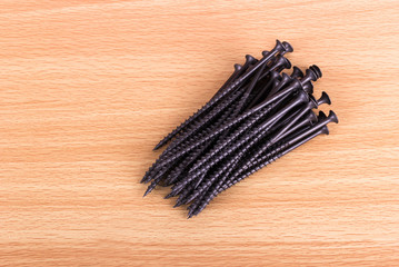 Nails on a light wooden background