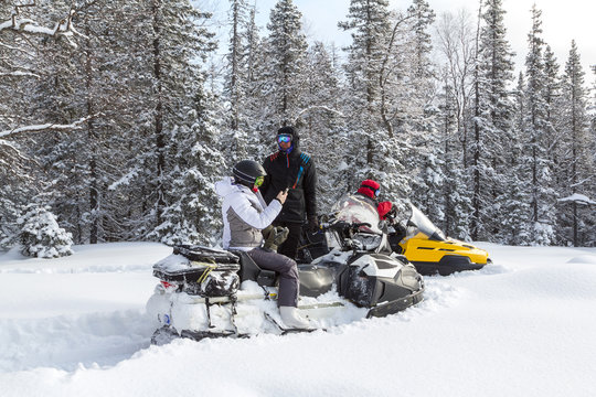 Athletes on a snowmobile