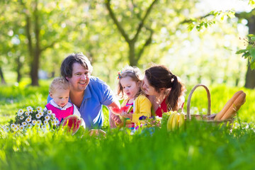 Family enjoying picnic in blooming garden