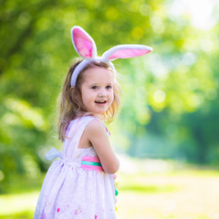 Little girl with white board for Easter greetings