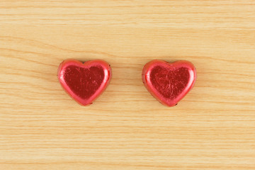 Obraz na płótnie Canvas chocolate candy red heart on wooden background.
