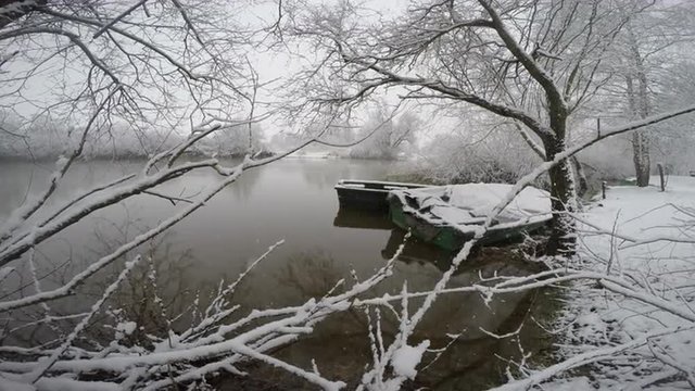 Boats on river in snowing