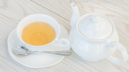a cup of tea with teapot 