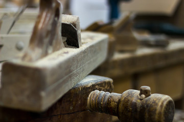 Old plane on a carpenter work bench Wood planer, Hand plane Selective focus and shallow Depth of...