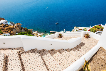Fototapeta na wymiar Stairs to the sea. White architecture on Santorini island, Greec