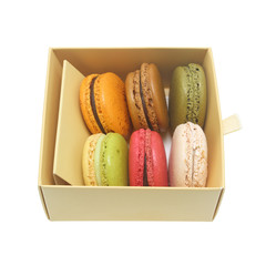 Tasty colorful macaroon in box paper on white background