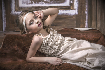 Obraz na płótnie Canvas Little girl beautiful fashion in gentle natural dress on a back
