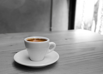 Coffee cup on the wooden table with color splash effect