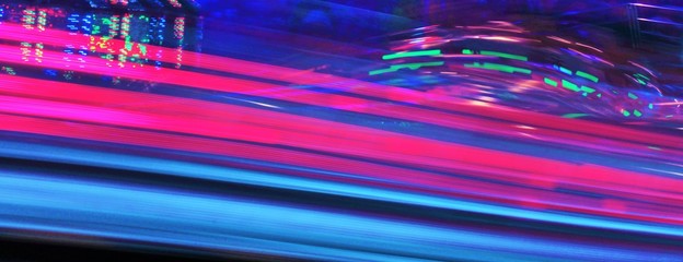 synth wave  neon disco lights fairground funfair ride Night colors in violet blue purple and pink of the amusement park stock, photo, photograph, picture, image, 