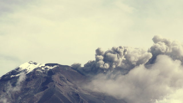 Witness the awe inspiring might of Tungurahua volcano as it unleashes a powerful explosion,engulfing Ecuador in dense clouds of ash and gases.
