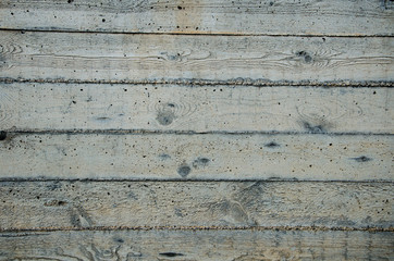 A concrete wall with horizontal traces of the wooden form.