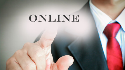 Businessman with red tie showing press on text "ONLINE", Technology and network concept.