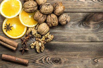 Christmas background. Christmas composition with oranges, walnuts and cinnamon on wood.