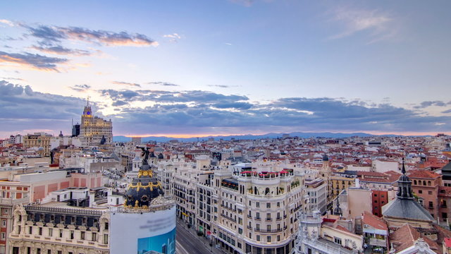 Panoramic aerial view of Gran Via timelapse at sunset, Skyline Old Town Cityscape, Metropolis Building, capital of Spain, Europe.