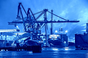 Container ship in port at night - Shipping concept.