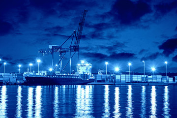 Fototapeta premium Container ship in port at night - Shipping concept.
