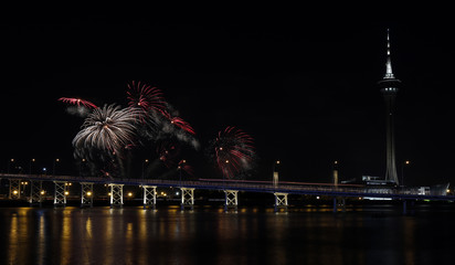 International firework shows light up the sky with dazzling display near Bridge Ponte de Sai Van and Macau tower