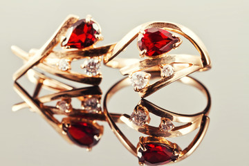 Fototapeta na wymiar gold earrings with rubies and alexandrites