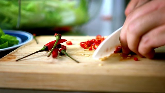 Man Cutting Chili Lettuce on Cutting Board with Ceramic White Knife - Close Up 60 fps