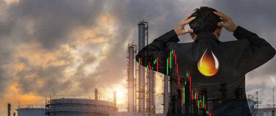business, people, crisis, finances and economics concept - businessman with Oil Nymex Graph showing falling oil prices in the market