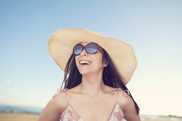 Portrait of beautiful woman in hat on summer vacation