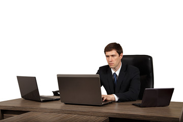 Businessman at his desk with a laptop, isolated on white background