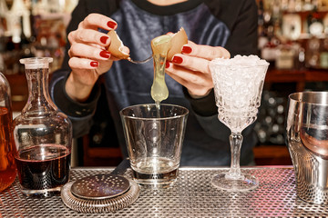 Bartender is adding egg white to the glass, toned