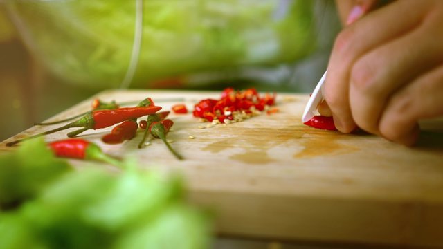 Man Cutting Chili on Cutting Board with Ceramic White Knife - Color Graded Close Up 4K Resolution