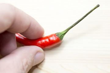 pick-up the red chili on the wooden background