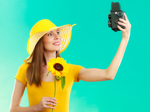 Summer woman holds sunflower old camera