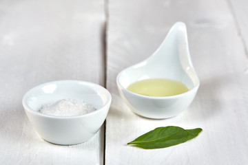 Salt and oil an a basil leaf