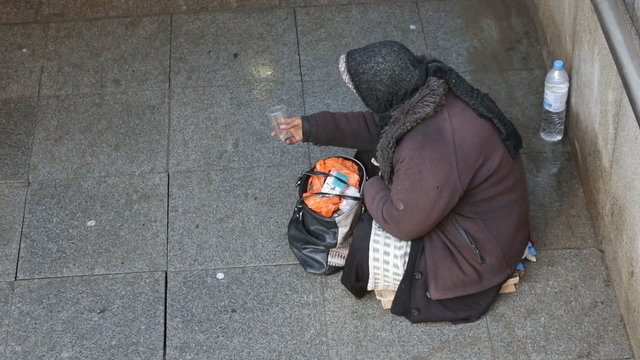 Anonymous woman is begging in the street of Sofia. Bulgaria is the poorest country in the European Union. HD.