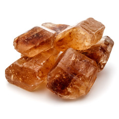 Brown caramelized lump cane sugar cube isolated on white backgro