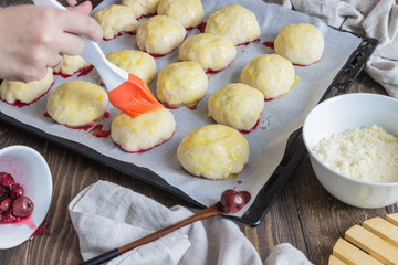 scones with cherries before baking, the ingredients, cherries, flour. Hands