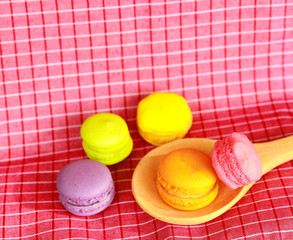 Colourful tasty macaroons in spoon