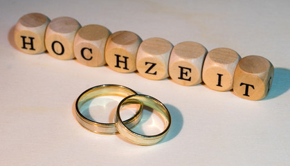 Wedding / Two wedding rings with wooden cubes with the german word wedding