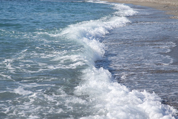 Wave on the pebble coast of sea. Selective focus