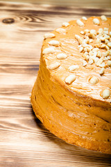 Homemade peanut cake on wooden background. Selective focus. Tone