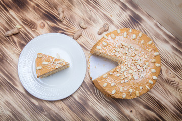 Homemade peanut cake on wooden background