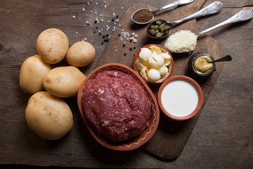 Set of ingredients for cooking on old wooden background