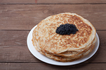 Black caviar on Russian pancakes - blini