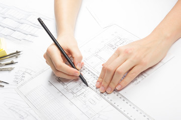 Architect working on blueprint. Architects workplace - architectural project, blueprints, ruler, calculator, laptop and divider compass. Construction concept. Engineering tools