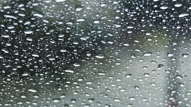 Rain, water drops on glass of the car, close-up
