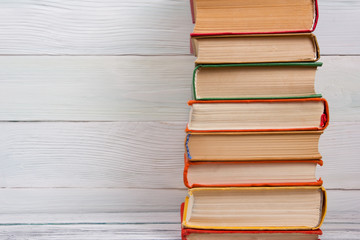 Stack of books on wooden table. Back to school. Copy space
