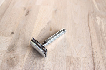 vintage chrome plated razor on a grain oak tree background