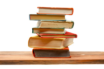 Fototapeta premium Stack of books at wooden shelf isolated on white background. Back to school. Copy space for text