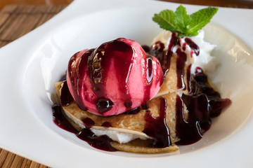 Close up on a plate of crepe and sorbet